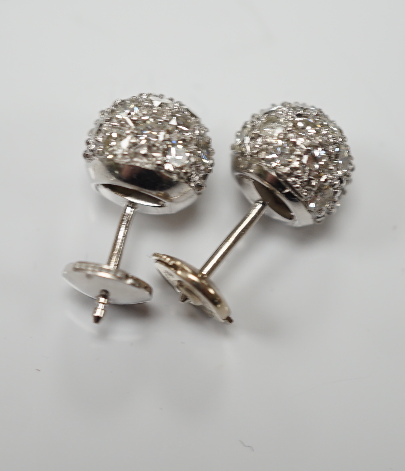 A modern pair of 18k white metal and pave set diamond spherical earrings, 9mm, gross 6.2 grams.